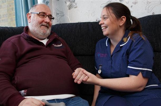 A photo of someone receiving home care by a hospice nurse