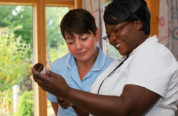Two hospice nurses working in a hospice