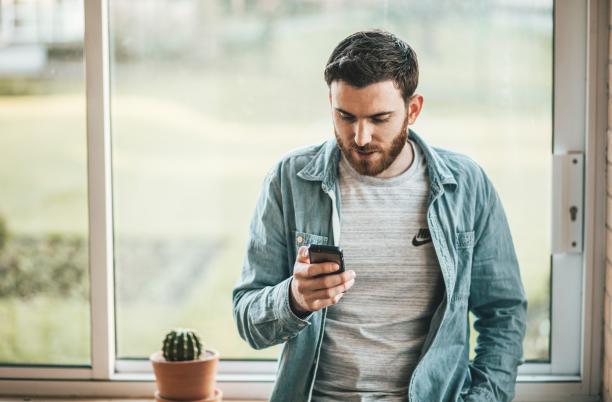 A stock photo of someone using a mobile phone