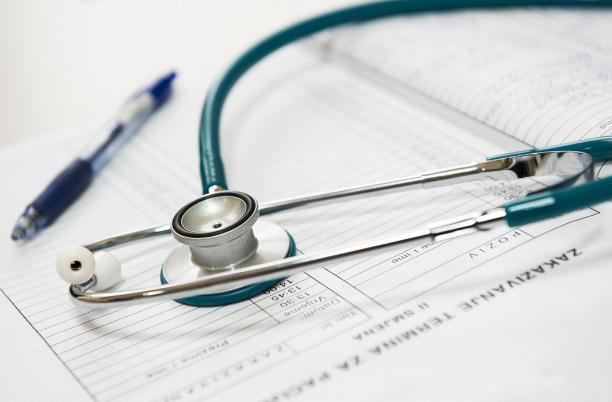 A stock photo of a stethoscope with clinical paperwork