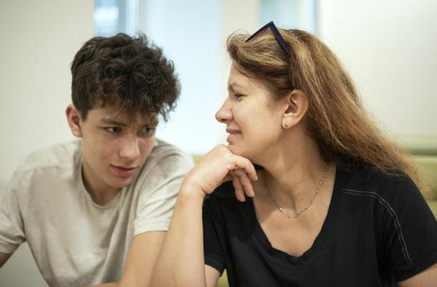 A woman looks at her son