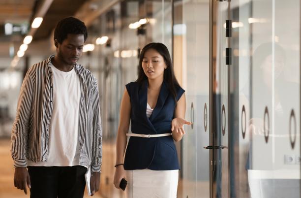 A man and a woman have a compassionate conversation at work