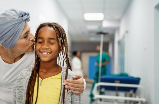 What to expect when someone is in the last few days of life. Woman in hospital kissing a young girl