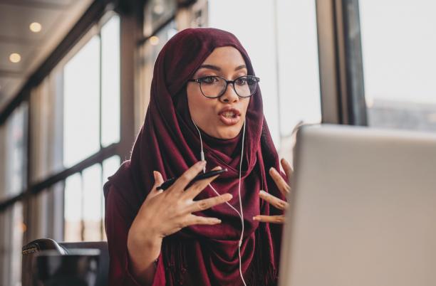 Stock photo of a woman having a conversation via her laptop