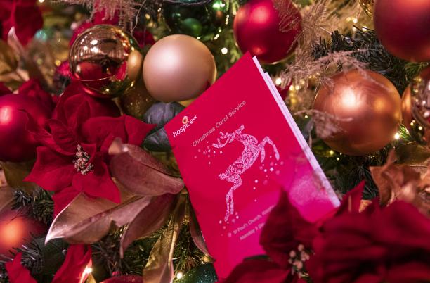 Red programme nestled in a christmas tree, decorated with baubles