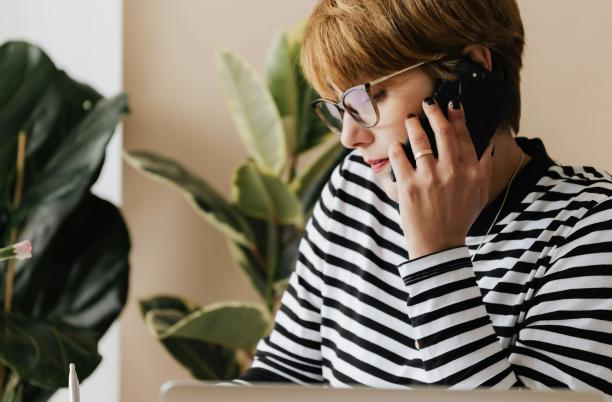 women speaking on phone with laptop