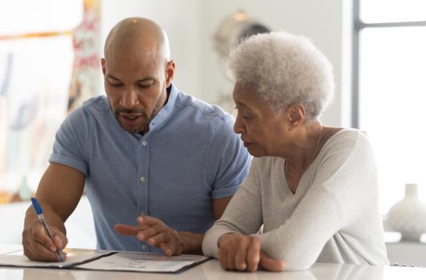 What to do when someone dies - an older woman with son writing a will