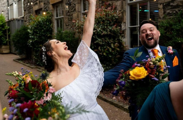 Bride and groom cheering