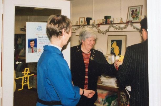 A snapshot from the past of a lady working in a charity shop