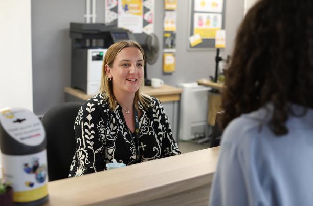 A photo of a member of hospice staff greeting a visitor