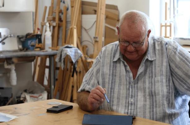 A man looking down at his desk
