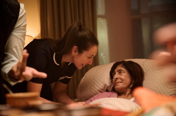 From This is Hospice Care legacy campaign - woman in bed at her home with hospice nurse by her side