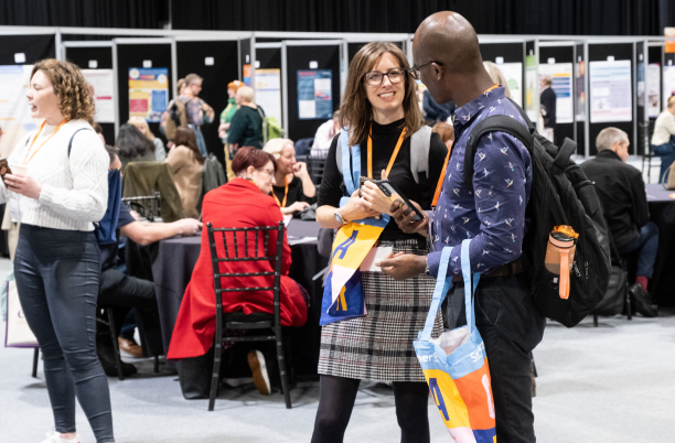 Two people talking in a conference exhibition space