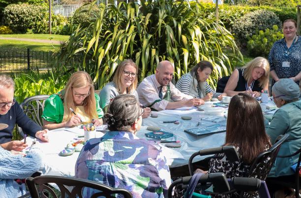 Patients at St Christopher’s Hospice get together to paint ‘Together Pebbles’ for the Hospice UK Garden of Compassion at RHS Chelsea Flower Show 2025 – with the help of comedian Tom Allen