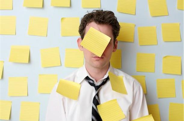 A stock photo of someone with a lot of post-it notes