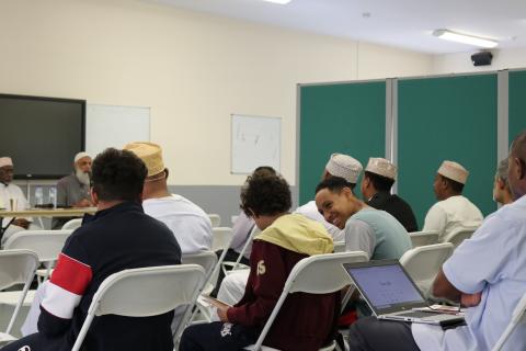 a group of people sitting down in a community centre