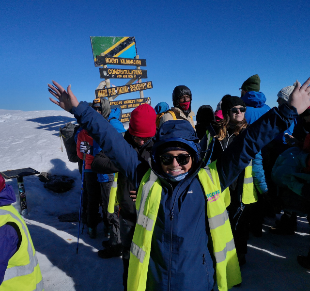 Cheering at the summit of mount kilimanjaro