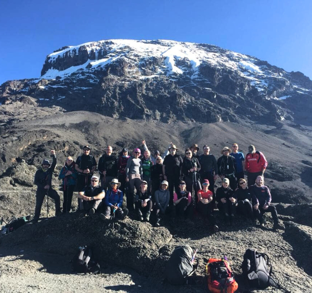 Group photo of walkers in front of mount kilimanjaro
