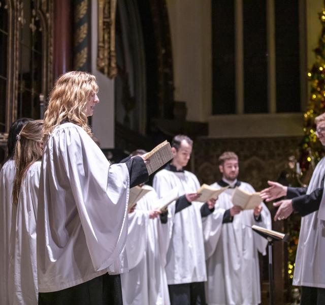 Choir singing in traditional wear at the front of the church