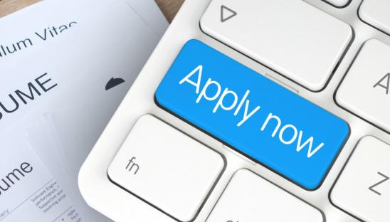 Stock photo of a keyboard with the shift key replaced with a blue Apply now button